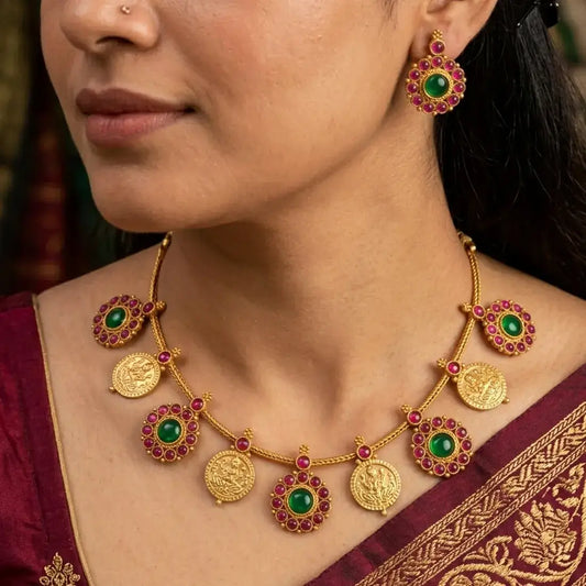 Antique Matte Floral Kemp Stone Lakshmi Kasu Necklace Set worn by a model, featuring floral medallions and gold coin pendants.