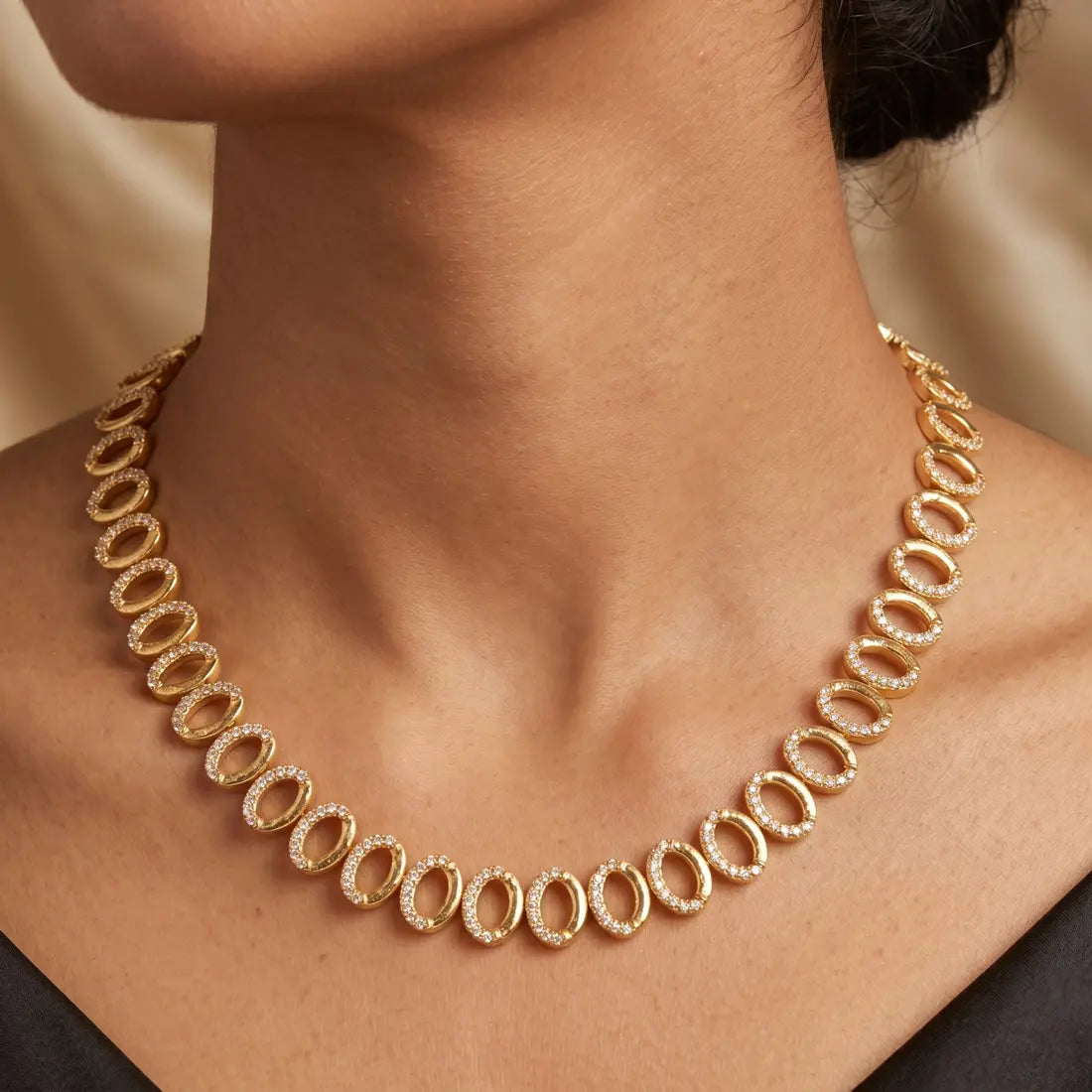 Gold Plated Oval CZ Stone Necklace worn with elegance showcasing its sparkling cubic zirconia stones.