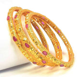 Premium Golden Ruby Stone Bangles Set featuring lustrous golden finish and vibrant ruby stones, perfect for any occasion.