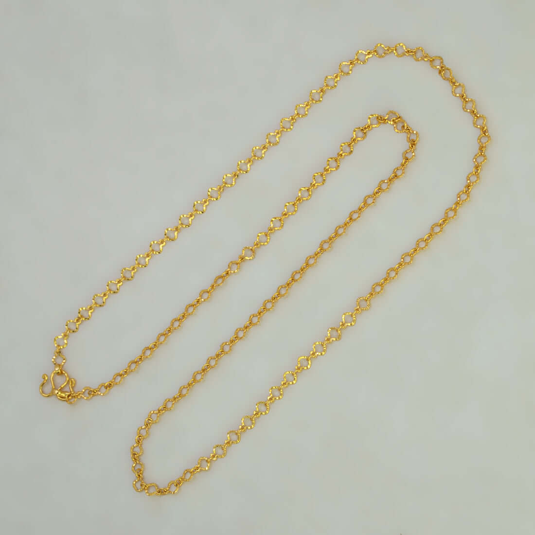 Light-Weight Gold Plated Pulimurugan Chain showcasing round links and polished finish on a neutral background.