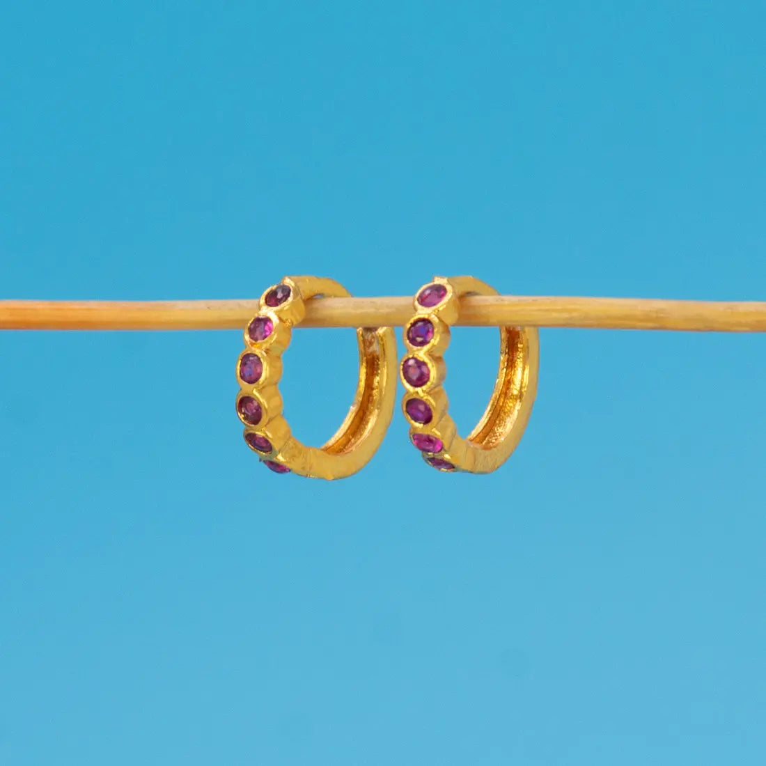 Gold Plated Stone Hoop Earrings for Women featuring purple stones set in a sleek gold finish.
