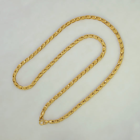 A gold-colored chain necklace with a textured, woven link design, displayed on a plain light gray background.