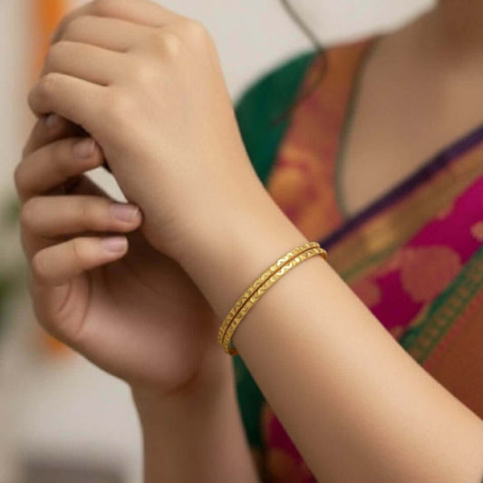 Trendy Gold-Plated Wavy Pattern Bangles worn by a woman, featuring a delicate textured design and refined golden finish.